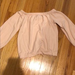 Woman’s pink off the shoulder sweatshirt